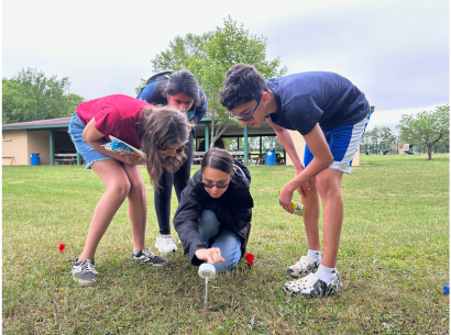  teacher and students conduct experiment